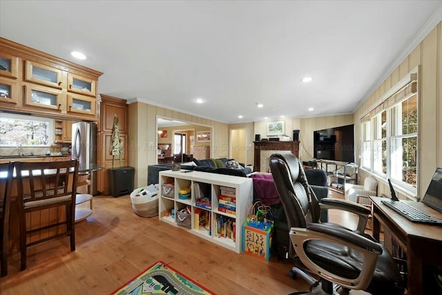 home office with light wood finished floors, a sink, recessed lighting, and ornamental molding