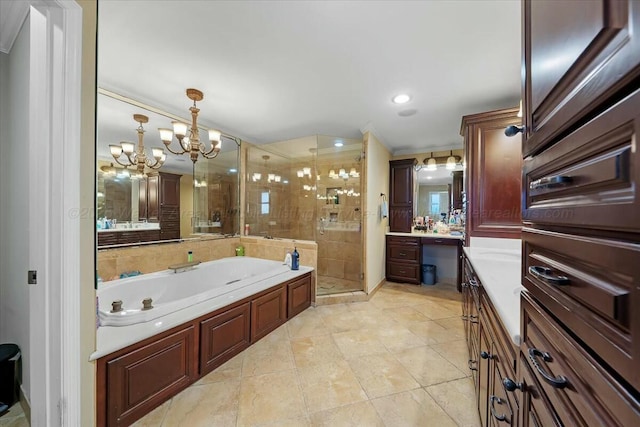 bathroom featuring a stall shower, tile patterned floors, vanity, a garden tub, and an inviting chandelier