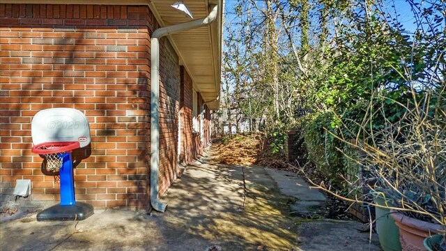 view of property exterior featuring brick siding