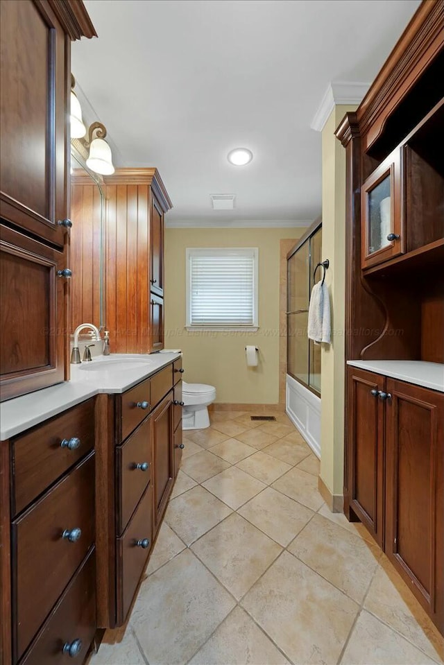 full bathroom with enclosed tub / shower combo, toilet, tile patterned flooring, and ornamental molding