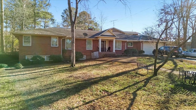 ranch-style house featuring a front lawn, a garage, and brick siding