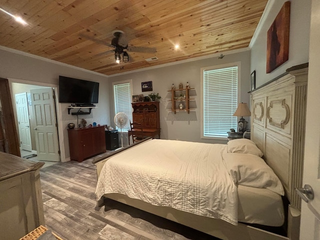 bedroom featuring crown molding, wood finished floors, and wooden ceiling