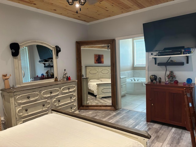 bedroom featuring ornamental molding, ensuite bath, wood finished floors, and wooden ceiling