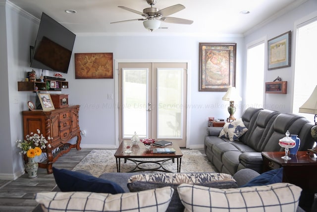 living area featuring baseboards, a ceiling fan, wood finished floors, and ornamental molding