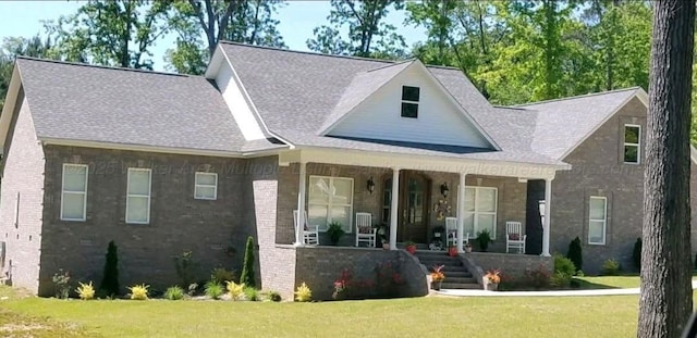 381 Gray Cir, Winfield, AL 35594 - view of front of home featuring covered porch, a front yard, a shingled roof, and brick siding