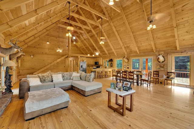 living room featuring ceiling fan, beam ceiling, wood ceiling, and light hardwood / wood-style flooring