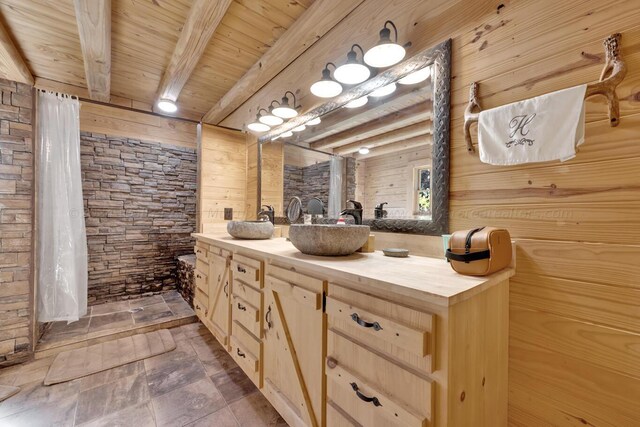 bathroom featuring beamed ceiling, vanity, wooden walls, and wood ceiling