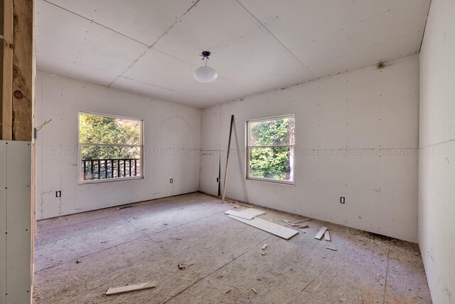 unfurnished room featuring a wealth of natural light