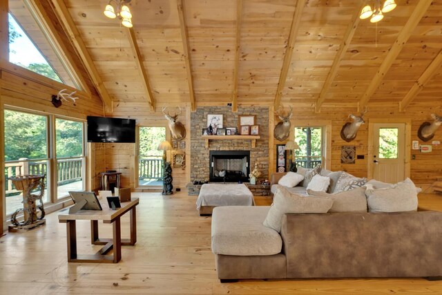 living room with hardwood / wood-style flooring, a wealth of natural light, and wood walls