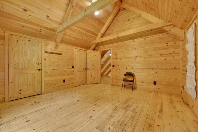 additional living space with wood-type flooring, wooden walls, and wooden ceiling