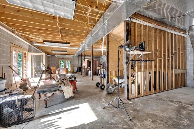 miscellaneous room with concrete flooring and a wealth of natural light