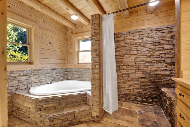 bathroom with wood ceiling, a washtub, beamed ceiling, and a healthy amount of sunlight