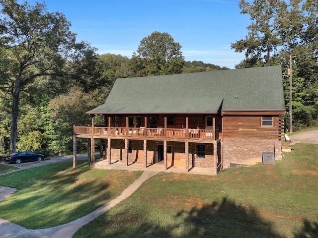 view of front of house with central air condition unit, a deck, and a front lawn