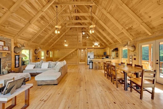 living room featuring beamed ceiling, light hardwood / wood-style floors, wood ceiling, and wooden walls