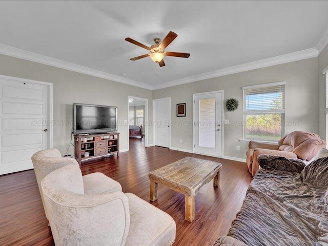living room with dark wood-style floors, crown molding, baseboards, and a ceiling fan