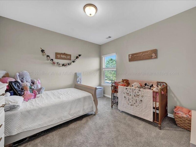 bedroom featuring baseboards, visible vents, and carpet