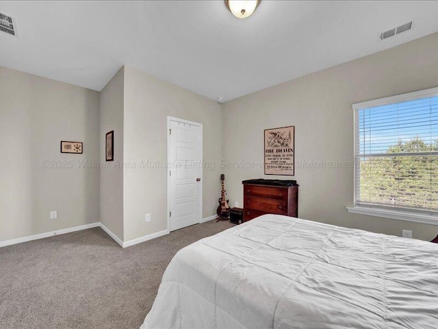 carpeted bedroom featuring baseboards and visible vents
