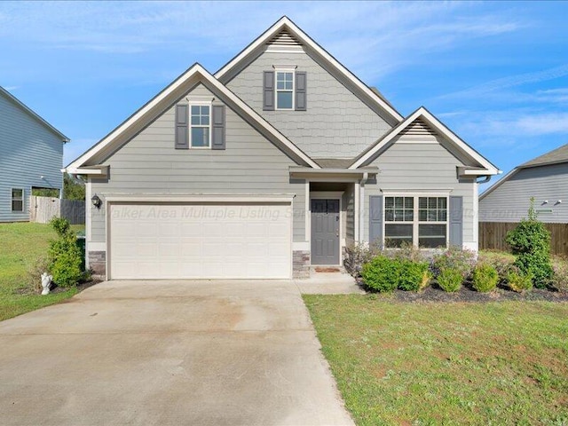 craftsman house with a front yard, driveway, a garage, and fence