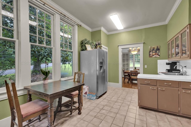 1600 Birmingham Ave, Jasper, AL 35501 - kitchen with stainless steel fridge with ice dispenser, crown molding, tile countertops, light tile patterned floors, and a chandelier