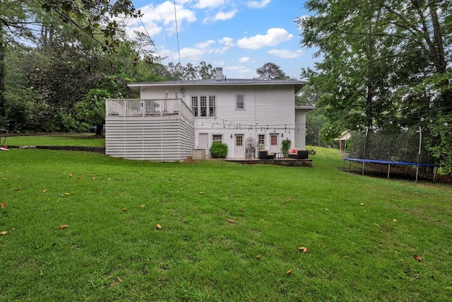 1600 Birmingham Ave, Jasper, AL 35501 - rear view of house featuring a trampoline, a yard, and a wooden deck