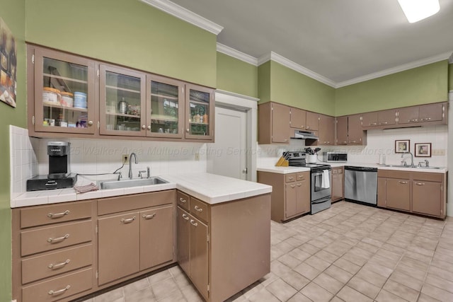 1600 Birmingham Ave, Jasper, AL 35501 - kitchen featuring appliances with stainless steel finishes, a peninsula, under cabinet range hood, tile countertops, and backsplash