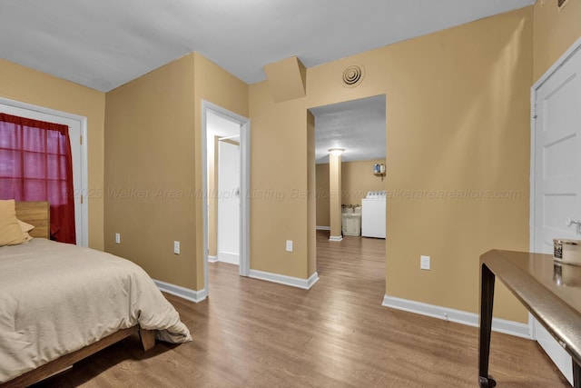 1600 Birmingham Ave, Jasper, AL 35501 - bedroom with wood finished floors and washer / dryer