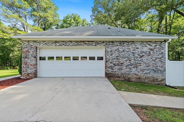 1812 N Walston Rd, Jasper, AL 35504 - view of side of home with brick siding, driveway, an attached garage, and a shingled roof