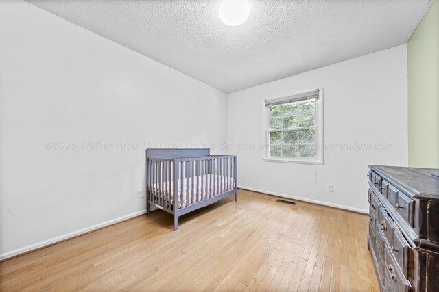 1812 N Walston Rd, Jasper, AL 35504 - bedroom with light wood-style floors and a textured ceiling