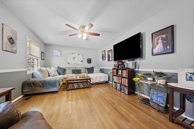 1812 N Walston Rd, Jasper, AL 35504 - living area with wood finished floors, a ceiling fan, and a textured ceiling