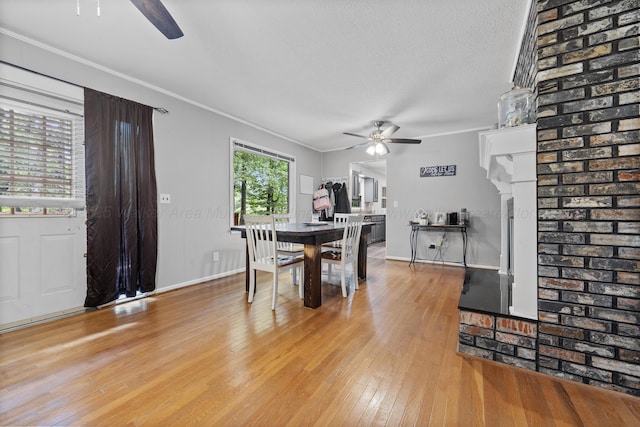 1812 N Walston Rd, Jasper, AL 35504 - dining area featuring a ceiling fan, ornamental molding, light wood finished floors, and a fireplace