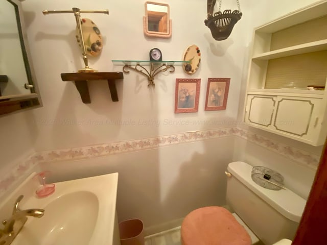 bathroom with toilet and a sink