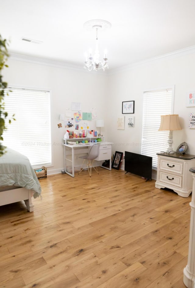 bedroom featuring light wood-type flooring, crown molding, and a chandelier