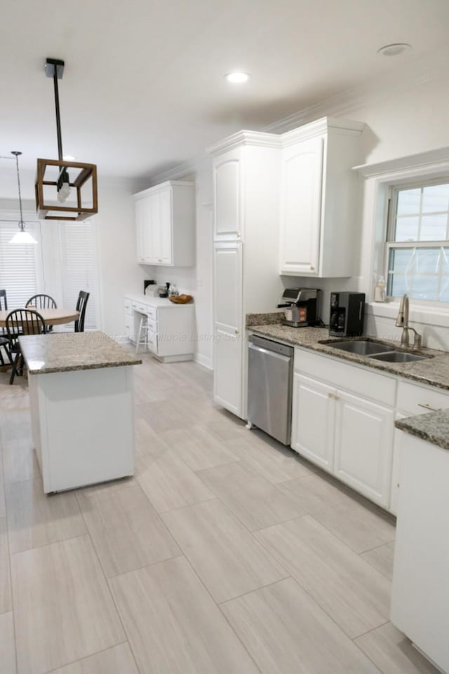 kitchen with white cabinets, decorative light fixtures, stainless steel dishwasher, and sink