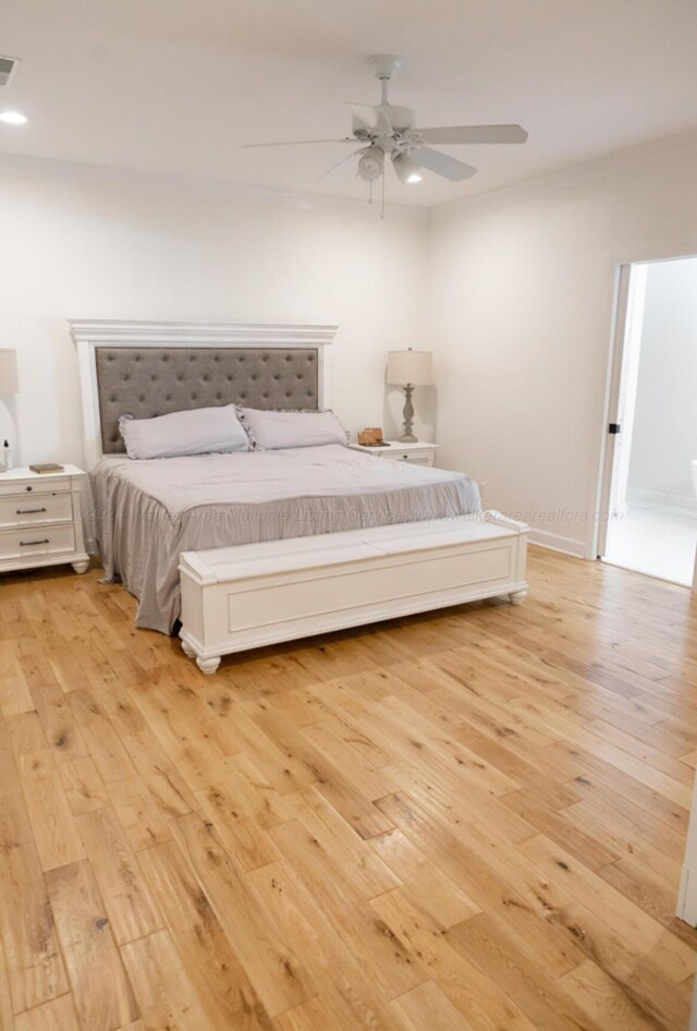 bedroom with ceiling fan and light hardwood / wood-style flooring