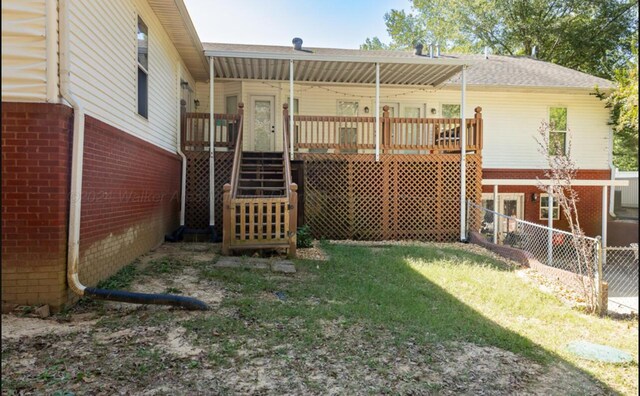 rear view of house featuring a deck