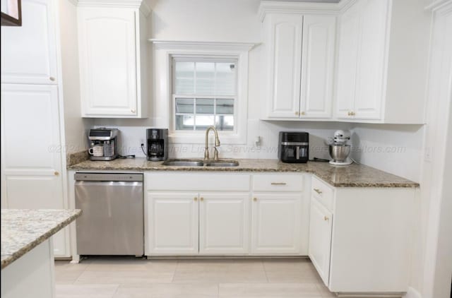 kitchen featuring white cabinets, dishwasher, light stone countertops, and sink