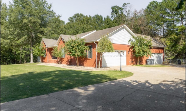 ranch-style home with a front yard and a garage