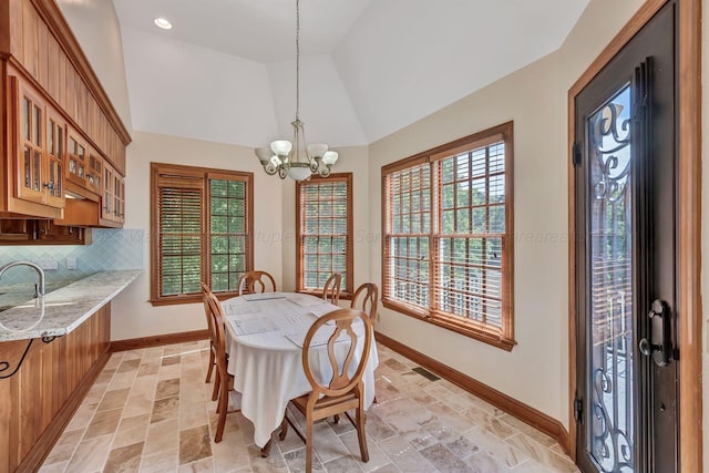 129 County Road 293, Cullman, AL 35057 - dining room featuring a chandelier, plenty of natural light, lofted ceiling, baseboards, and stone tile floors