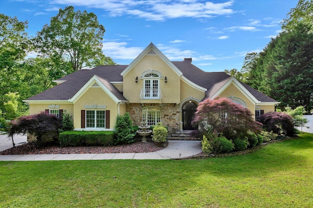 129 County Road 293, Cullman, AL 35057 - view of front of home with stucco siding, stone siding, and a front lawn
