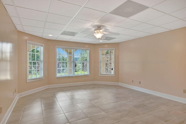 129 County Road 293, Cullman, AL 35057 - empty room featuring a drop ceiling, light tile patterned flooring, ceiling fan, healthy amount of natural light, and baseboards
