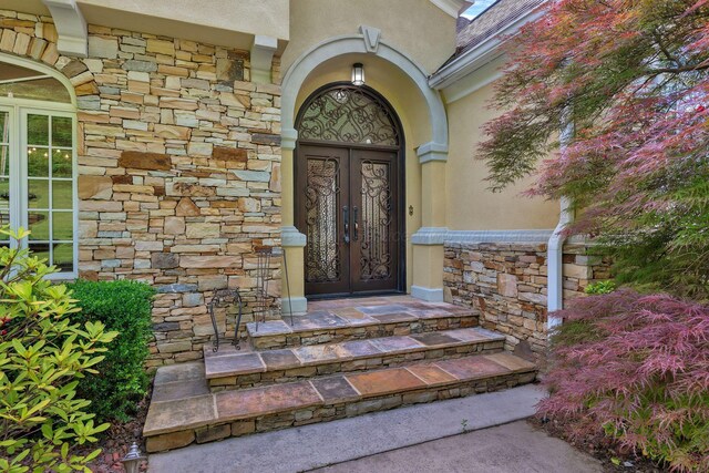 129 County Road 293, Cullman, AL 35057 - doorway to property with stucco siding, french doors, and stone siding