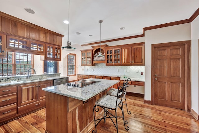 129 County Road 293, Cullman, AL 35057 - kitchen featuring brown cabinets, black electric stovetop, a sink, backsplash, and a center island