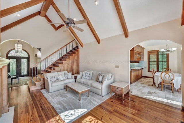129 County Road 293, Cullman, AL 35057 - living area featuring a chandelier, arched walkways, french doors, light wood finished floors, and high vaulted ceiling