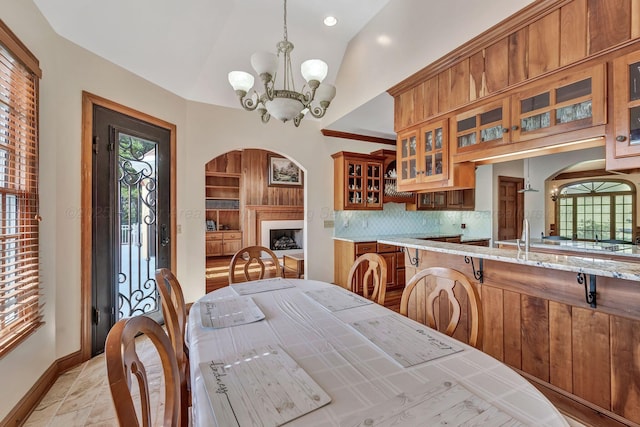 129 County Road 293, Cullman, AL 35057 - dining area with a chandelier, plenty of natural light, baseboards, lofted ceiling, and arched walkways