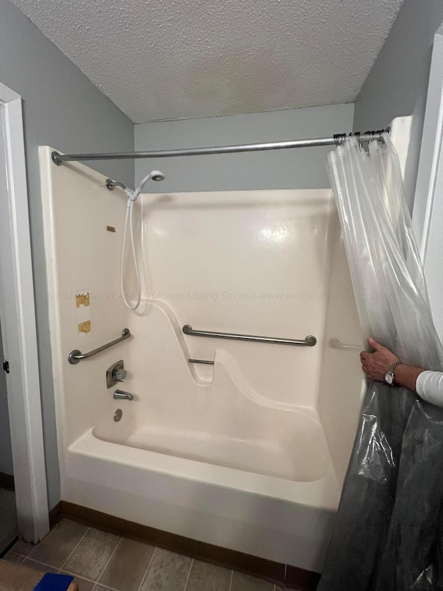 9670 Smith Lake Rd, Jasper, AL 35504 - bathroom featuring shower / bathtub combination with curtain, a textured ceiling, and tile patterned floors
