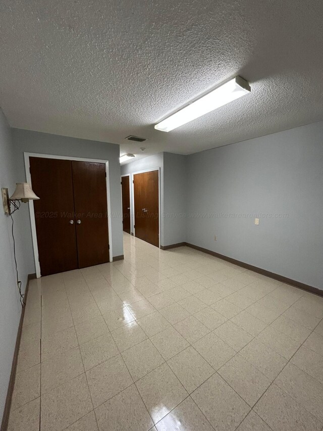 9670 Smith Lake Rd, Jasper, AL 35504 - corridor with a textured ceiling and tile patterned floors
