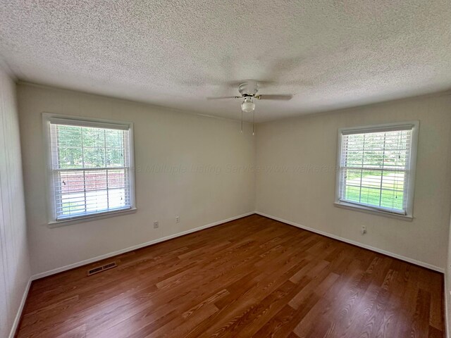 312 Crescent Cir, Jasper, AL 35503 - unfurnished room with wood finished floors, healthy amount of natural light, a ceiling fan, and a textured ceiling