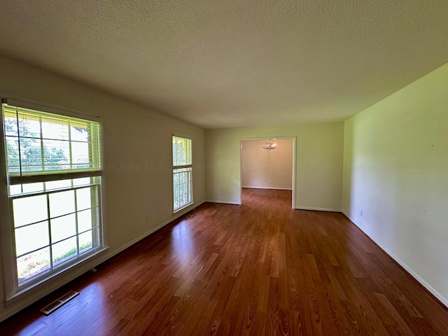 312 Crescent Cir, Jasper, AL 35503 - unfurnished room with a chandelier, dark wood-type flooring, and a textured ceiling