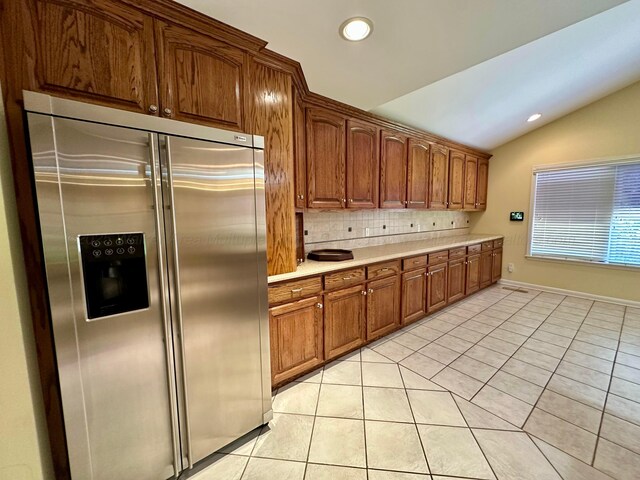 312 Crescent Cir, Jasper, AL 35503 - kitchen with high end refrigerator, tasteful backsplash, vaulted ceiling, light tile patterned floors, and light countertops