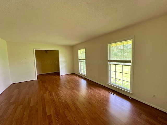 312 Crescent Cir, Jasper, AL 35503 - empty room with dark wood-style flooring and a textured ceiling